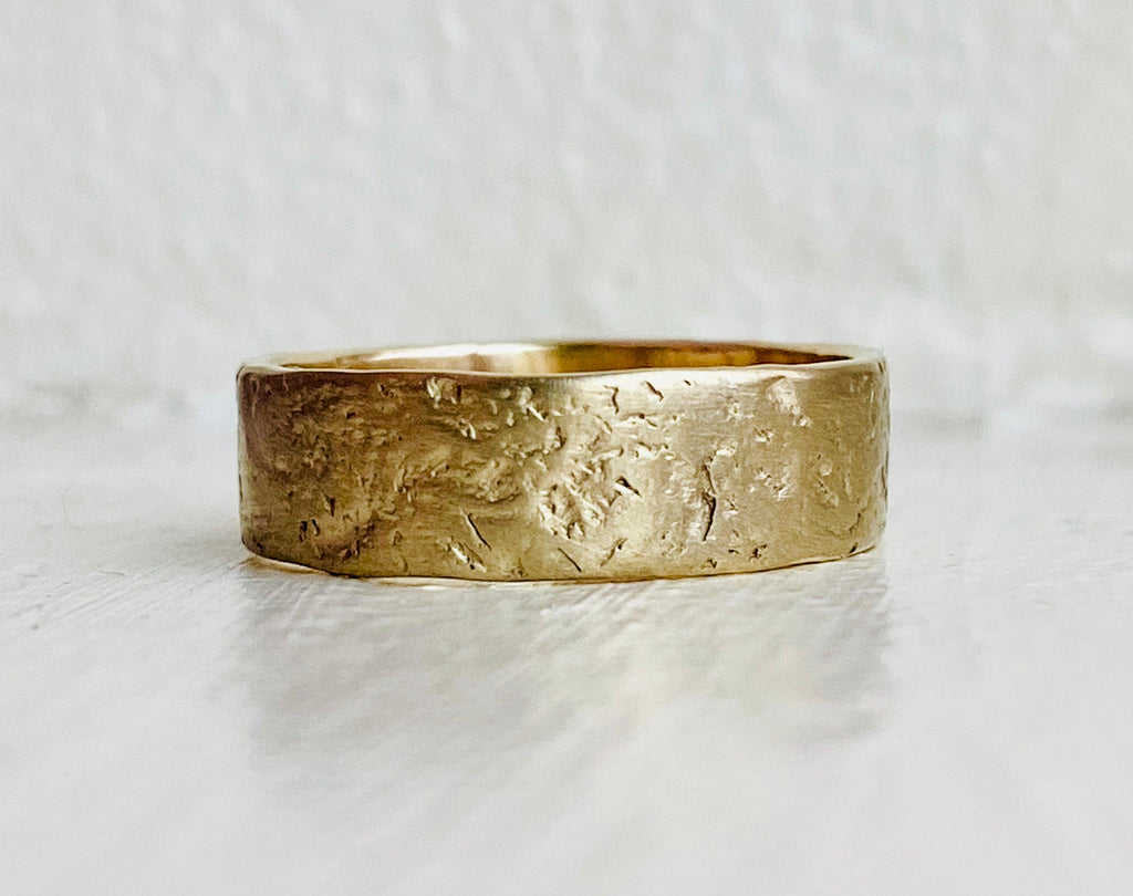 Textured Wedding Band with teal sapphire engagement ring on white background